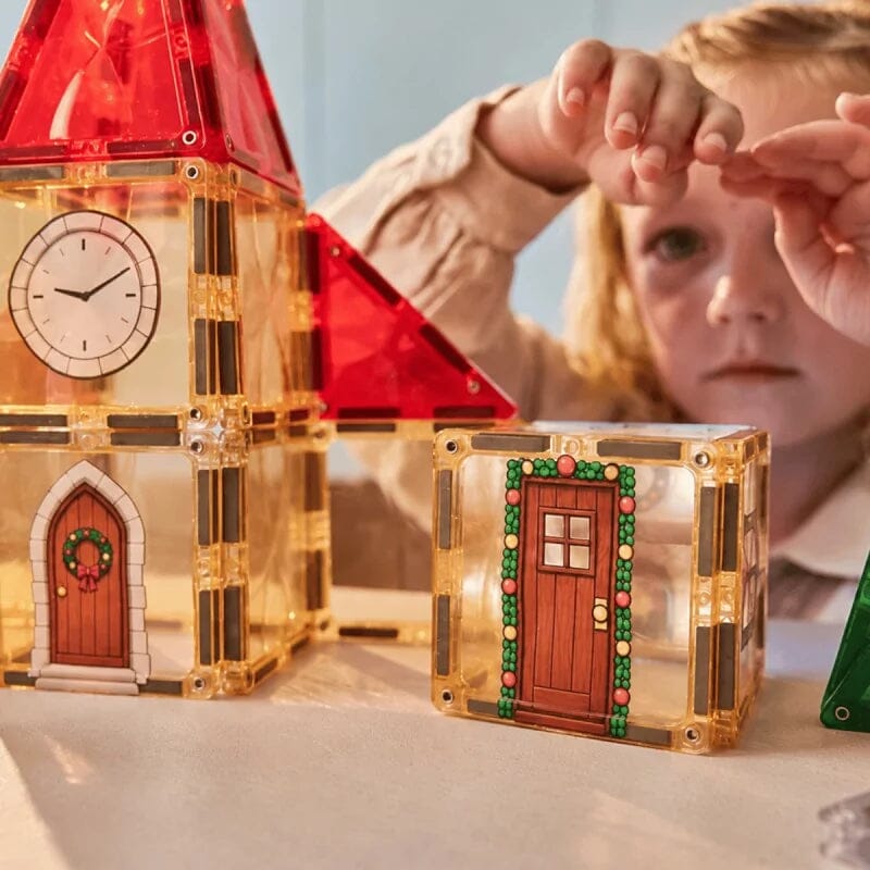 Enfant qui construit le village de Noël Cleverclixx